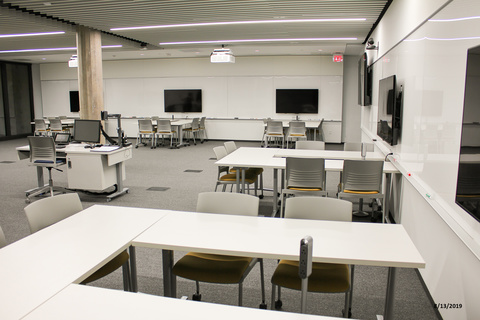 Image of classroom with tables in groups of three